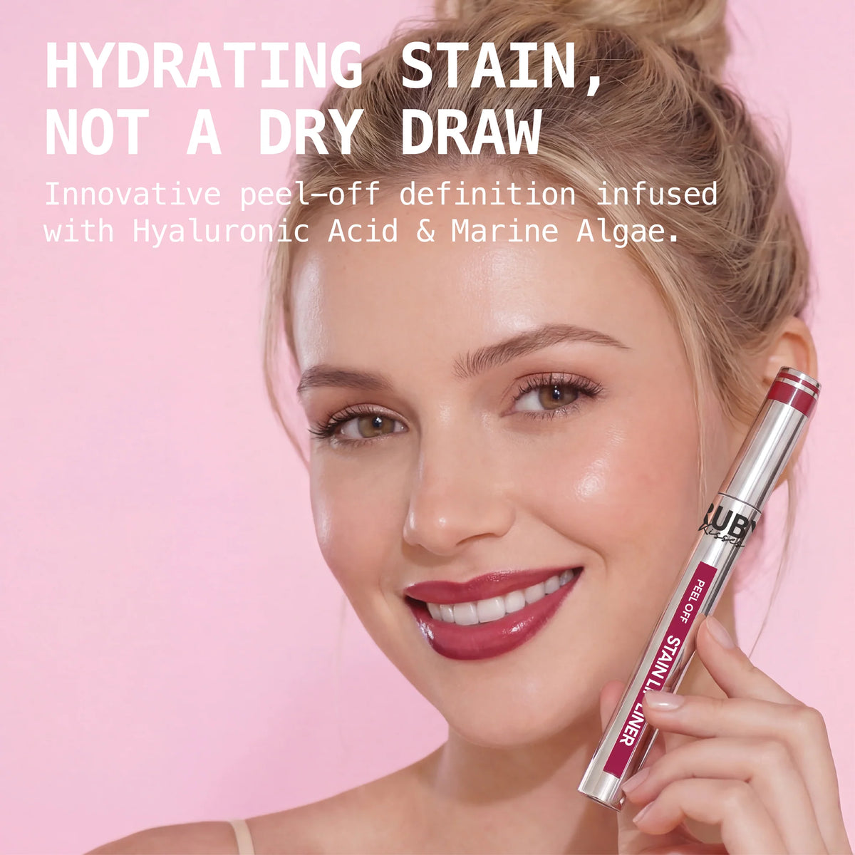 Peel-off stain lip liner with applicator brush, deep berry shade, held beside face.